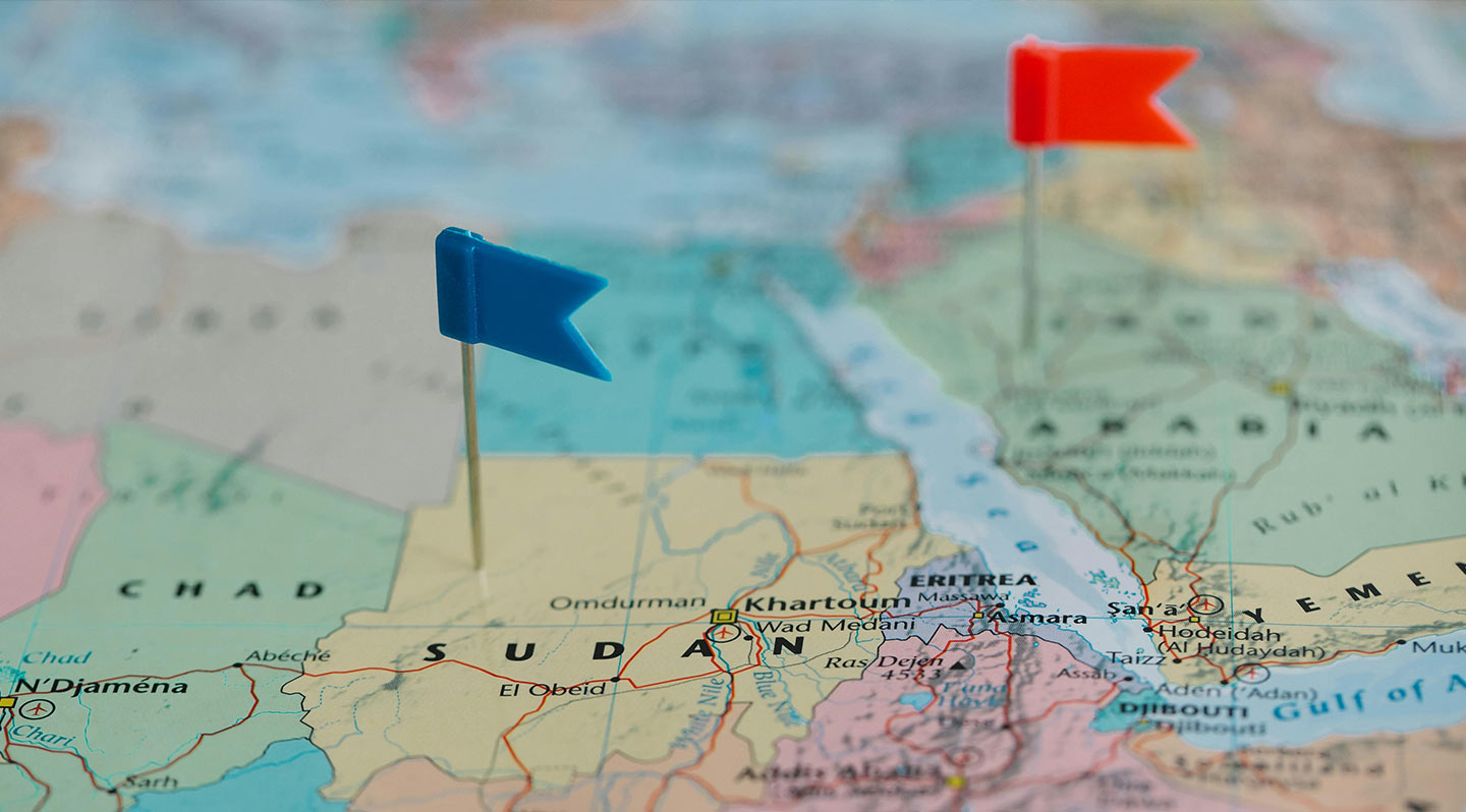 Image of a map showing Sudan with a blue flag pin.
