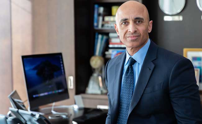 Yousef Al Otaiba stands in an embassy office