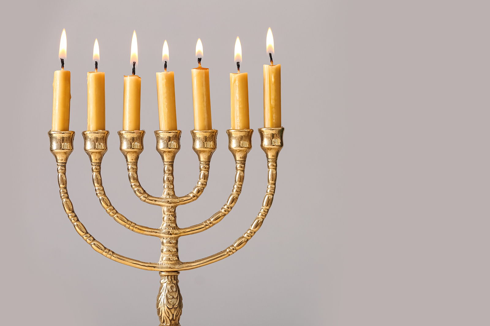 A golden menorah with all seven candles burning.