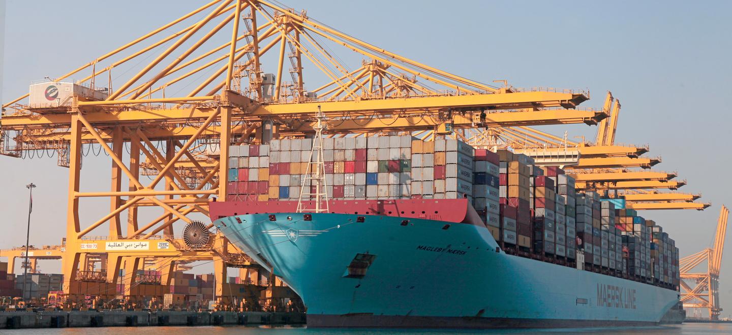 A trading ship carrying large storage containers.