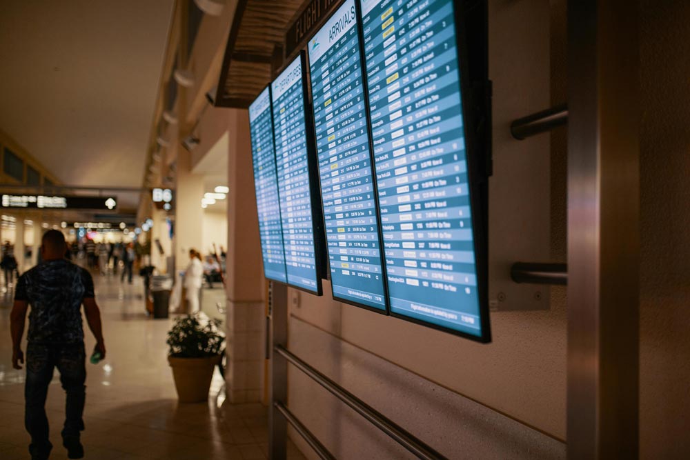 Photo of an arrivals and departures screen in an airport.