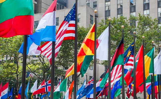 A group of international flags fly in front of the UAE Embassy in Washington, DC.